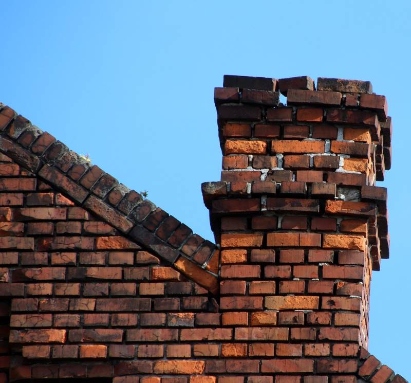 Damaged chimney on an Santa Ana home showing cracks and missing mortar